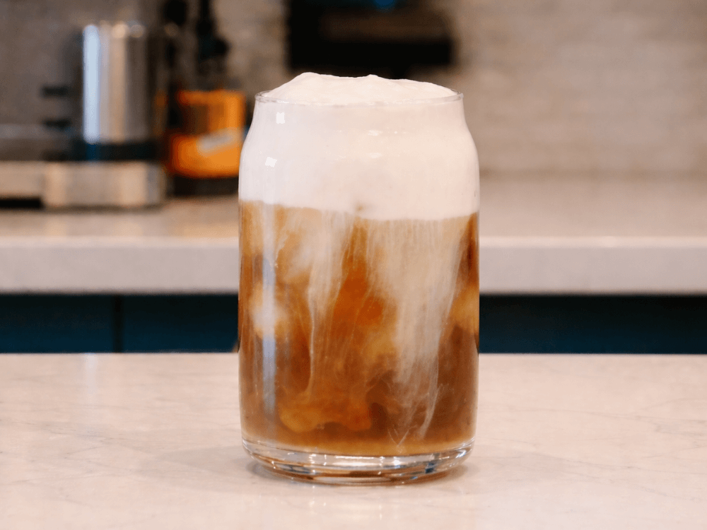 Vanilla Cold Foam served on an iced latte in a glass
