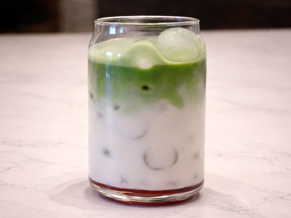iced blueberry matcha latte in a glass